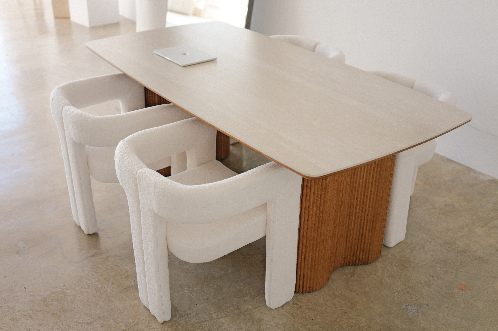 Large work table with four bouclé chairs in Studio 1112