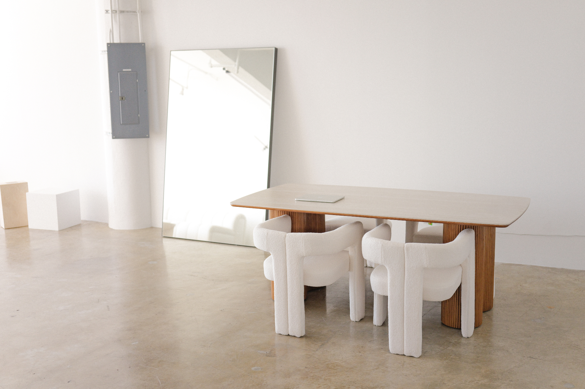 Work table and full-length mirror in the white interior of Studio 1112