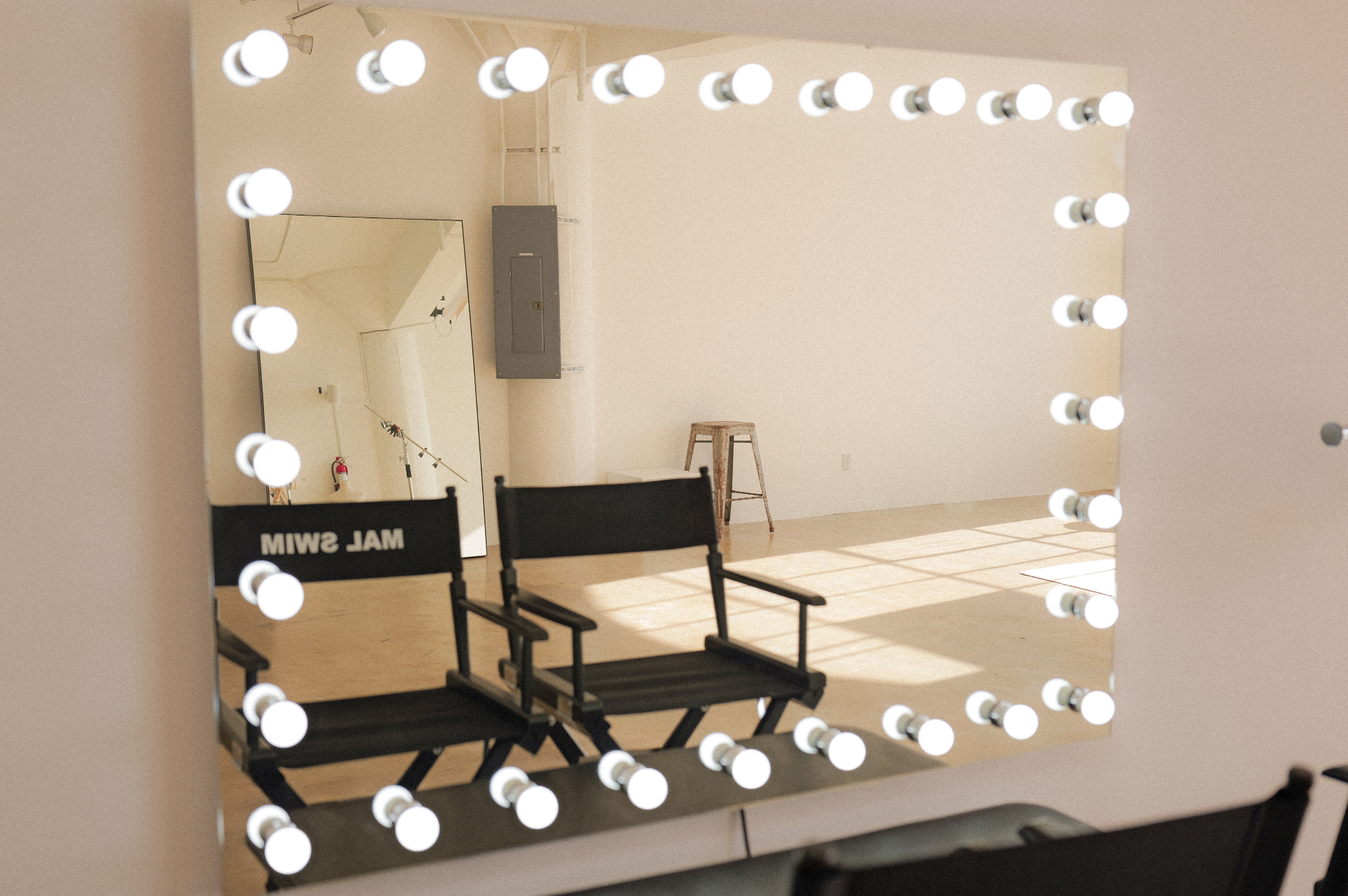 Lighted vanity mirror and director chairs in Studio 1112